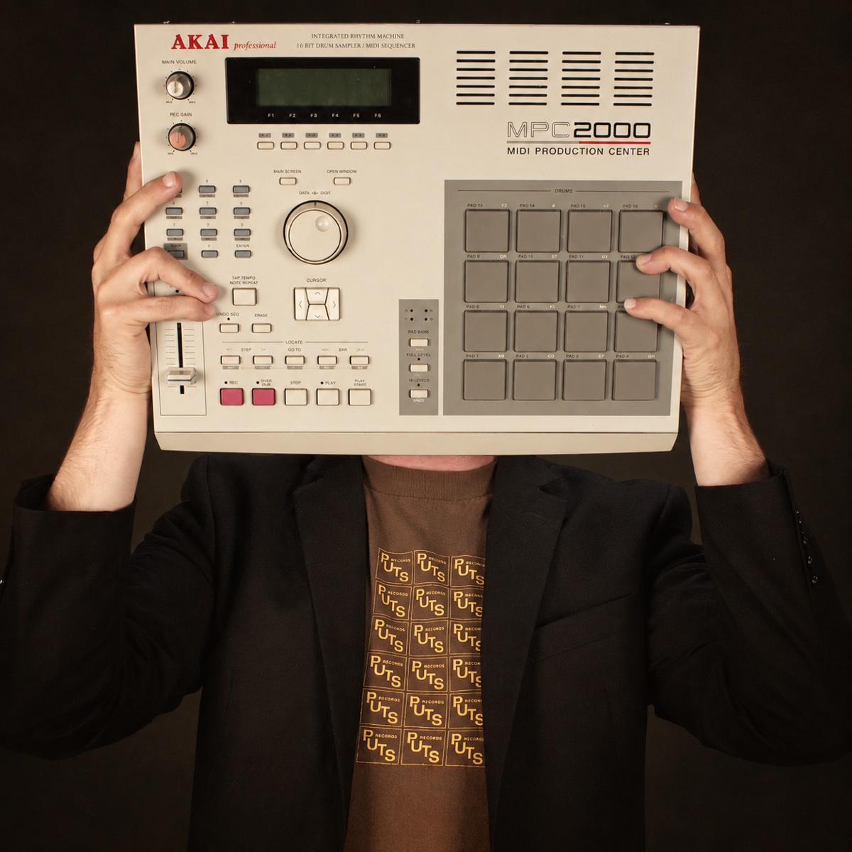 Tizz holding an Akai MPC2000 in front of his face